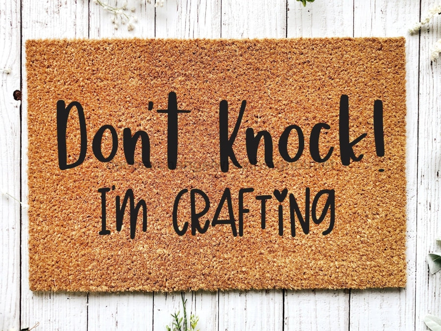 https://www.decoexchange.com/cdn/shop/files/dont-knock-im-crafting-doormat-crafter-gift-welcome-mat-funny-craft-gifts-housewarming-room-sign-door-mats-272_900x675.jpg?v=1688716099